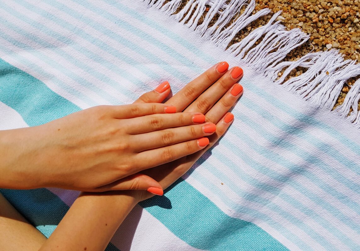 bright summer nails on beach towel